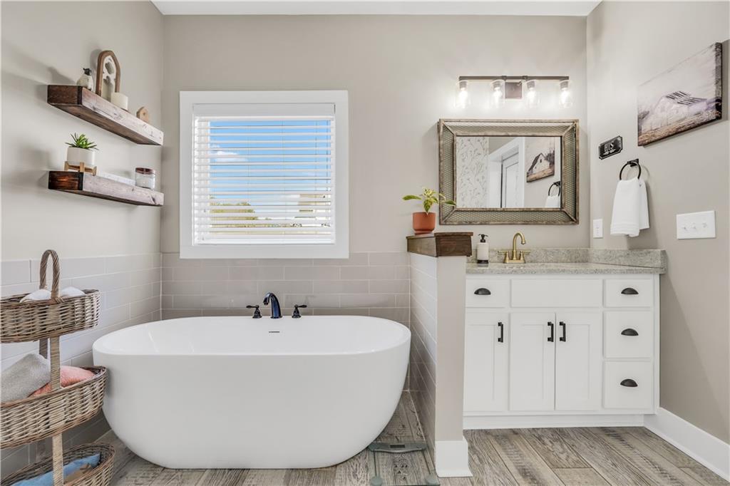 230 Alcovy Reserve Way Covington, GA 30014 - Photo 40 of 53 a white bath tub sitting next to a bathroom sink