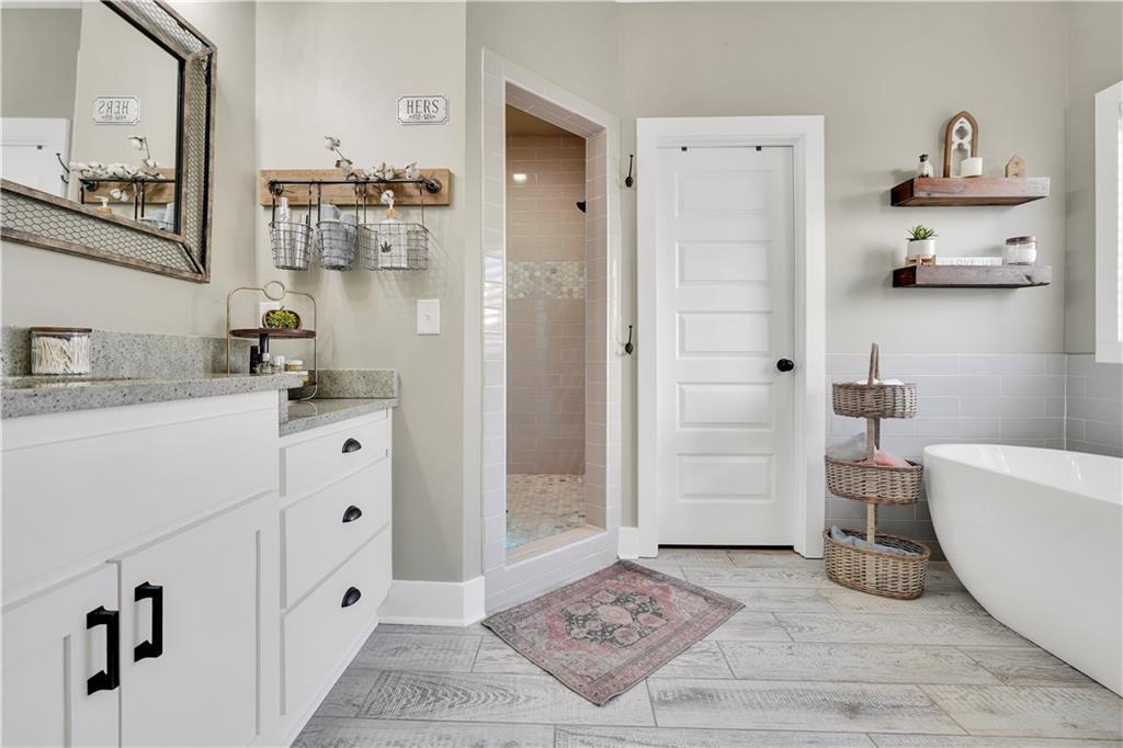 230 Alcovy Reserve Way Covington, GA 30014 - Photo 42 of 53 a bathroom with a tub sink and mirror