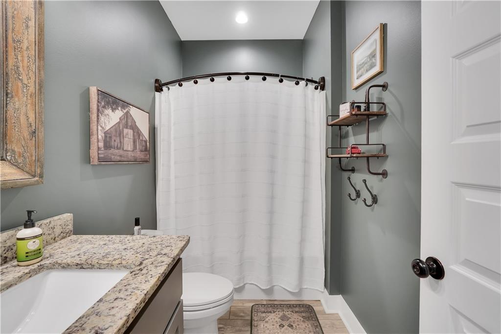 230 Alcovy Reserve Way Covington, GA 30014 - Photo 47 of 53 a bathroom with a granite countertop sink a toilet and shower