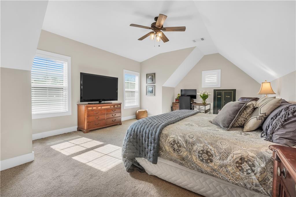 230 Alcovy Reserve Way Covington, GA 30014 - Photo 50 of 53 a bedroom with a bed flat screen tv and a couch