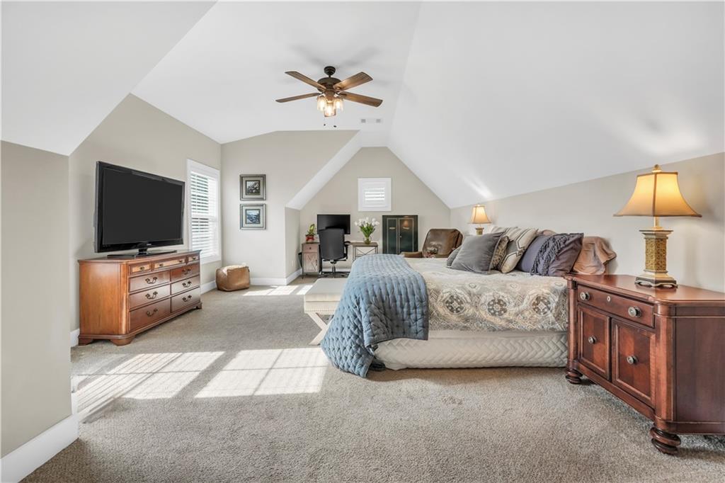 230 Alcovy Reserve Way Covington, GA 30014 - Photo 51 of 53 a spacious bedroom with a bed and a flat screen tv