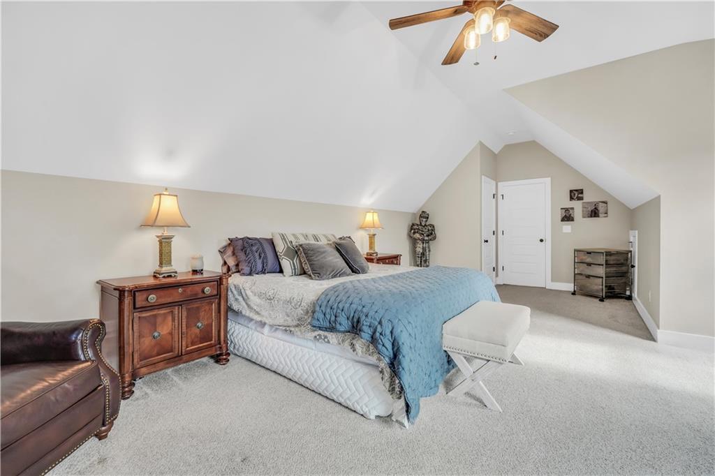 230 Alcovy Reserve Way Covington, GA 30014 - Photo 52 of 53 a spacious bedroom with a bed and ceiling fan