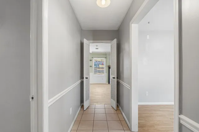 an empty room with a window and a ceiling fan