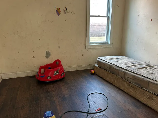 a bedroom with a bed and a window