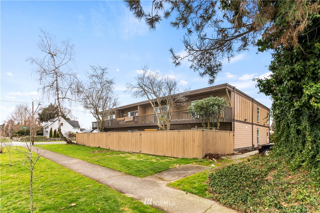 a front view of a house with a yard and an outdoor seating