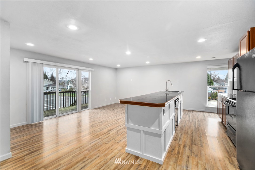 1103 Thompson Street Sumner, WA 98390 - Photo 10 of 29 a view of a big room with wooden floor and windows