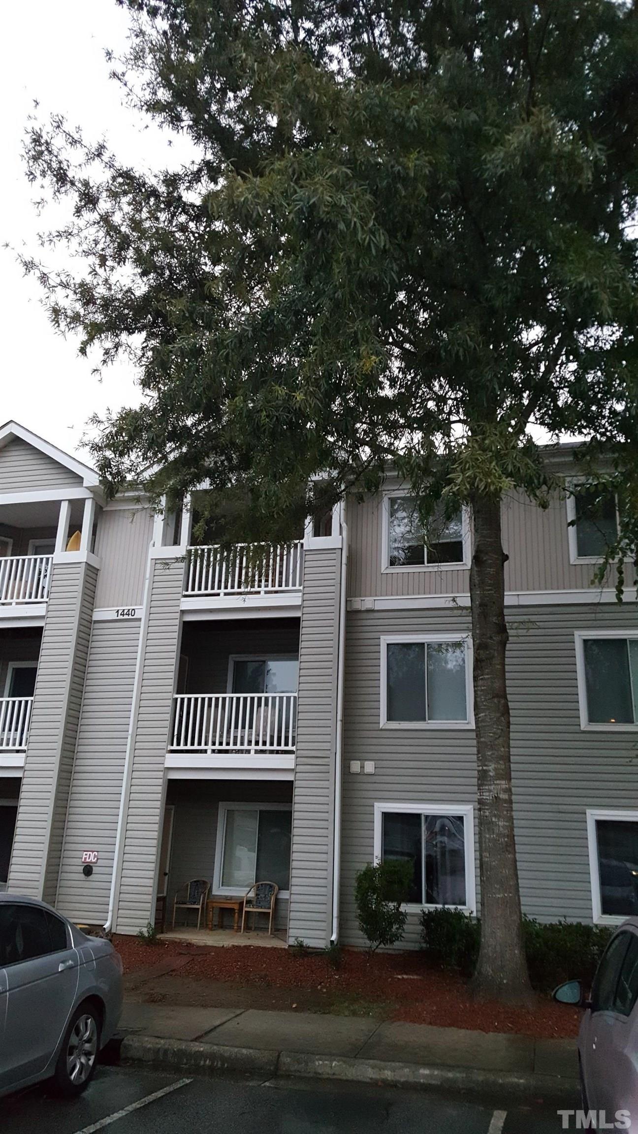 1440 Collegiate Circle, Unit 103 Raleigh, NC 27606 - Photo 3 of 10 a view of a house with a yard