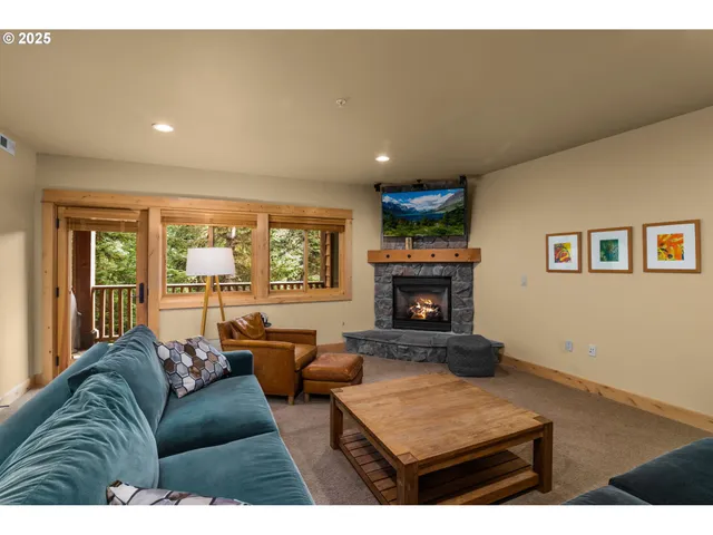 a living room with furniture a fireplace and a large window