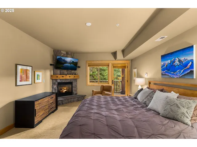 a bedroom with a bed and a fireplace