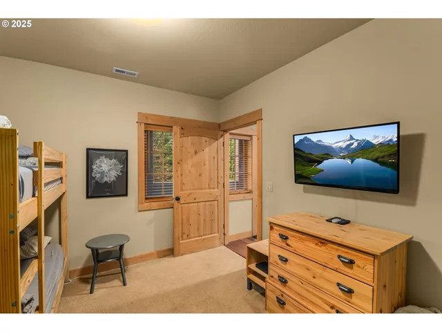 a bedroom with a bed and a night stand