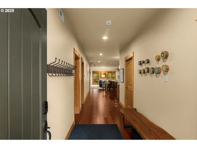 a view of a hallway and a livingroom with furniture
