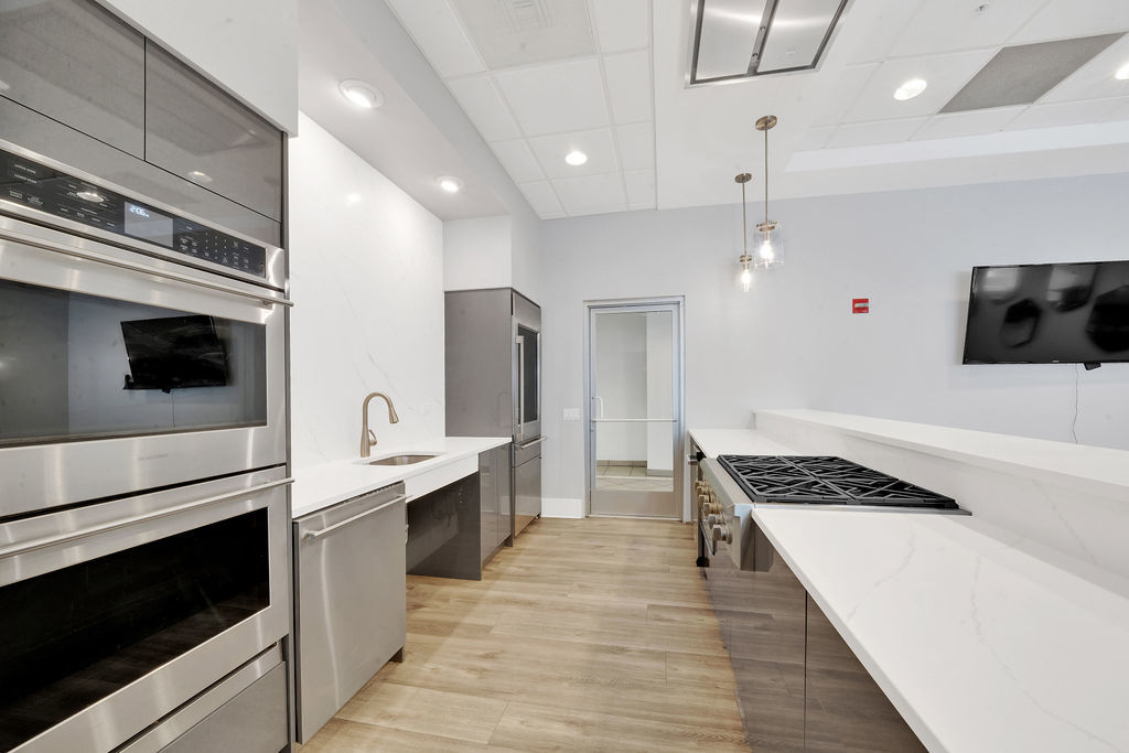 545 North Dearborn Street, Unit 2510 Chicago, IL 60654 - Photo 18 of 37 a kitchen with stainless steel appliances kitchen island a stove and a refrigerator
