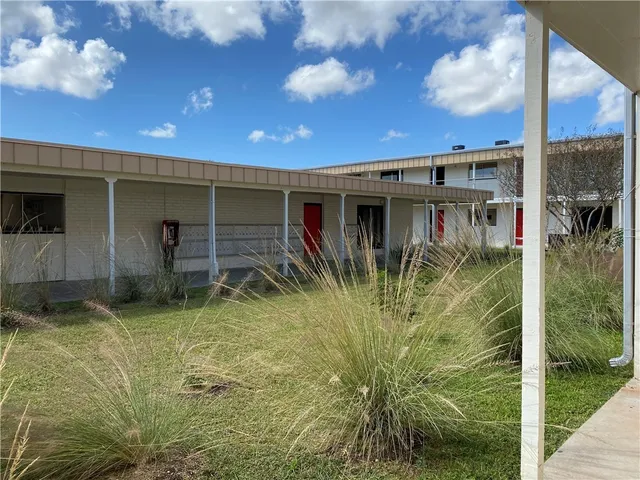 a backyard of a house with plants and garden