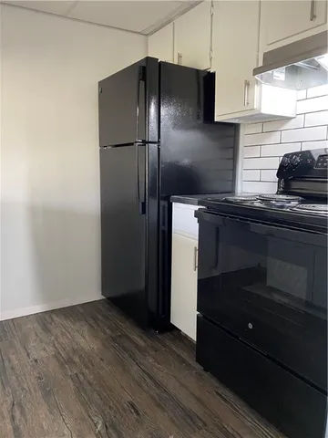 a kitchen with a refrigerator and a sink