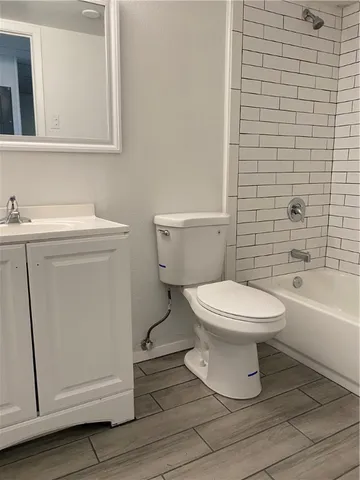 a white toilet sitting next to a bathroom sink
