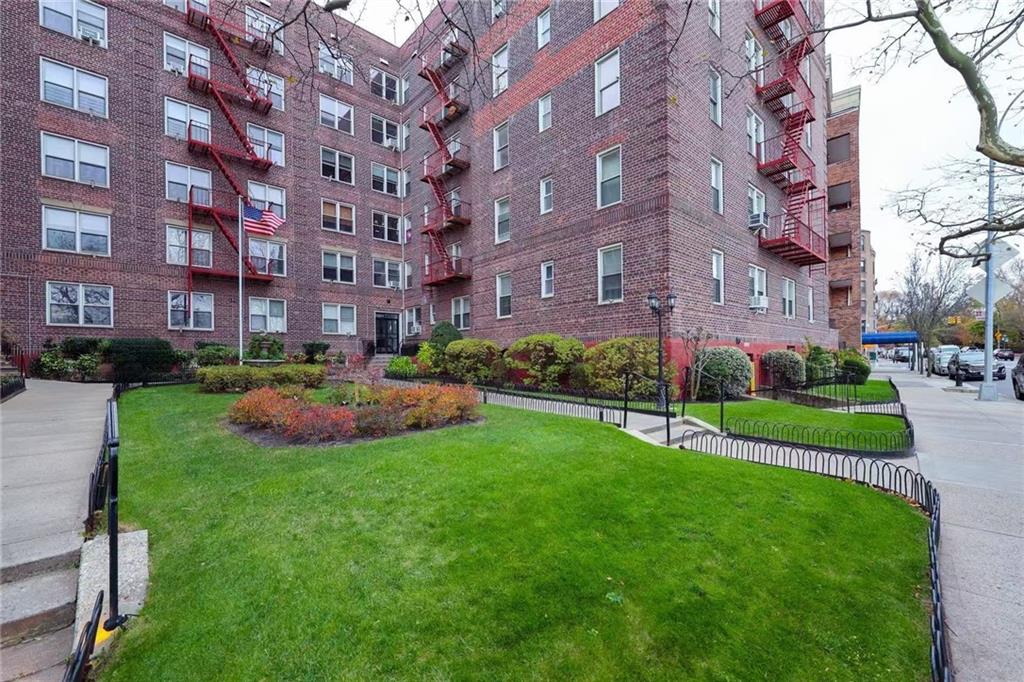 6801 Shore Road, Unit 2T Brooklyn, NY 11220 - Photo 17 of 20 a view of a big building with a big yard and plants