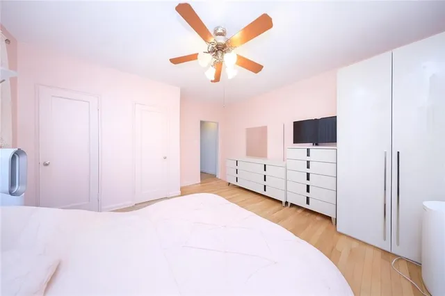 a view of a livingroom with wooden floor and a ceiling fan