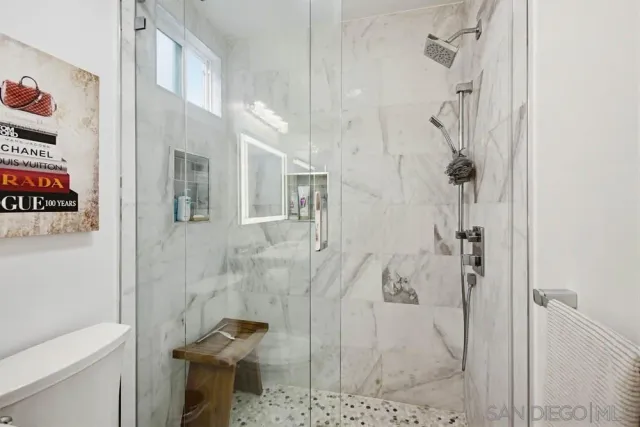 a living room with a couch and a ceiling fan