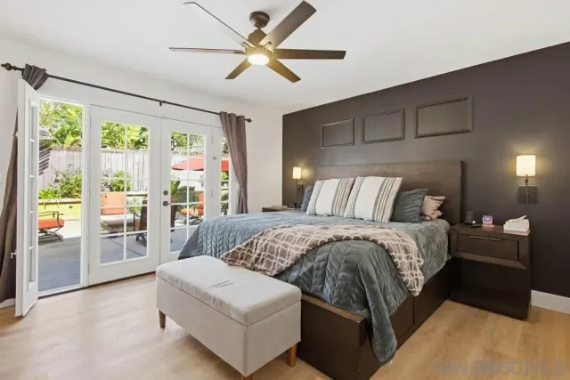 a bed room with a bed a television and a large window