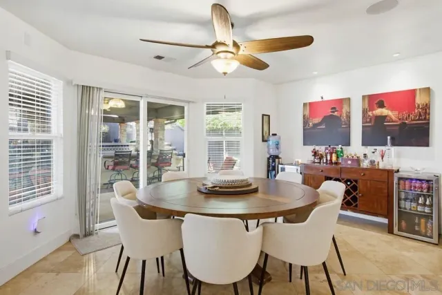 a large kitchen with a table and chairs