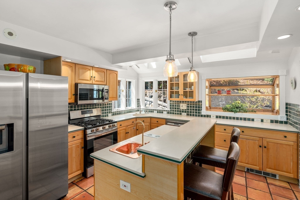 80 Fenwick Road Newton, MA 02468 - Photo 15 of 35 a kitchen with a stove a sink a kitchen island a stove and a refrigerator