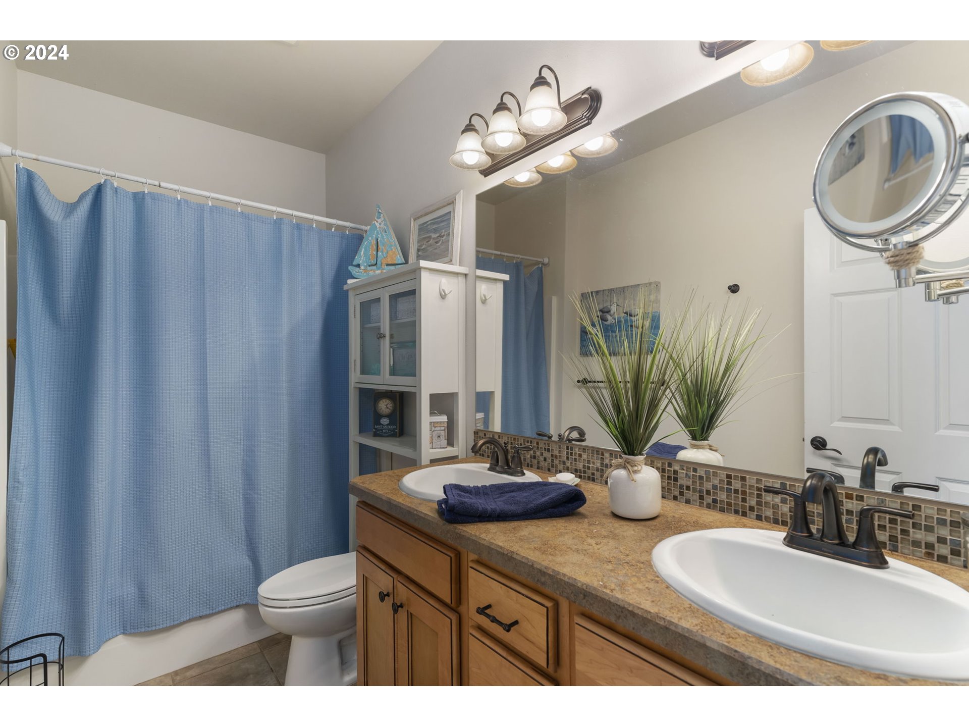 810 Miller Street Winlock, WA 98596 - Photo 21 of 29 a bathroom with double vanity a sink and a mirror