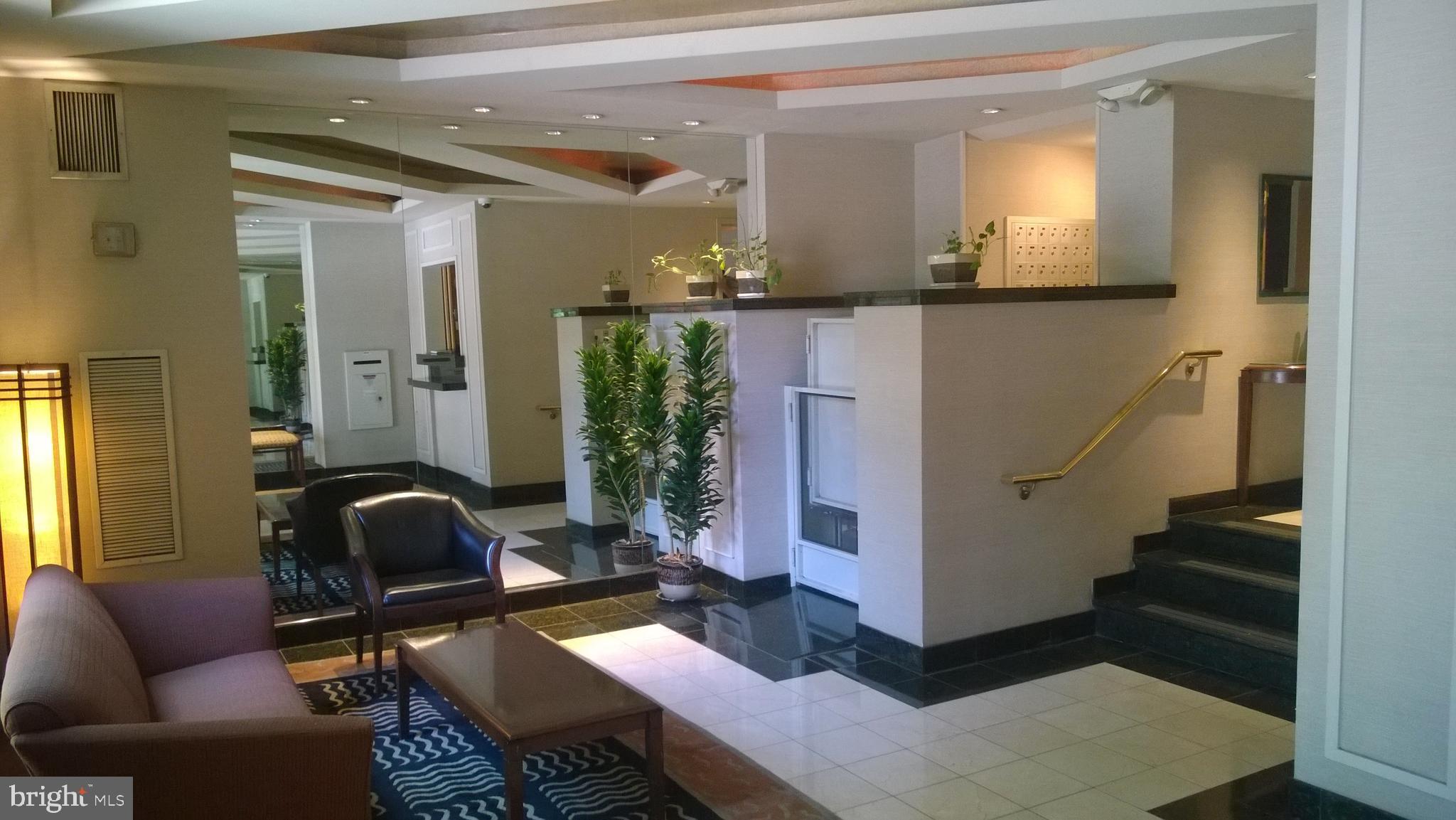 1301 20th Street Northwest, Unit 1003 Washington, DC 20036 - Photo 3 of 9 a living room with furniture and wooden floor