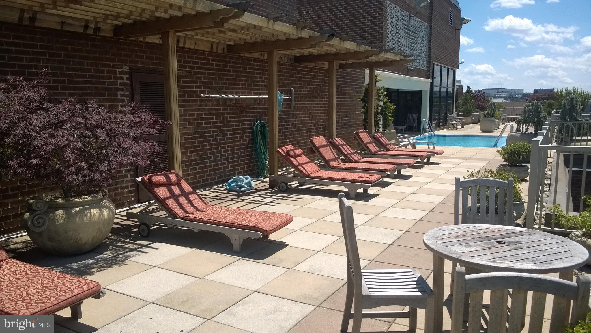 1301 20th Street Northwest, Unit 1003 Washington, DC 20036 - Photo 6 of 9 a view of a patio with table and chairs and potted plants
