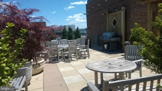 a view of a patio with table and chairs potted plants with wooden fence