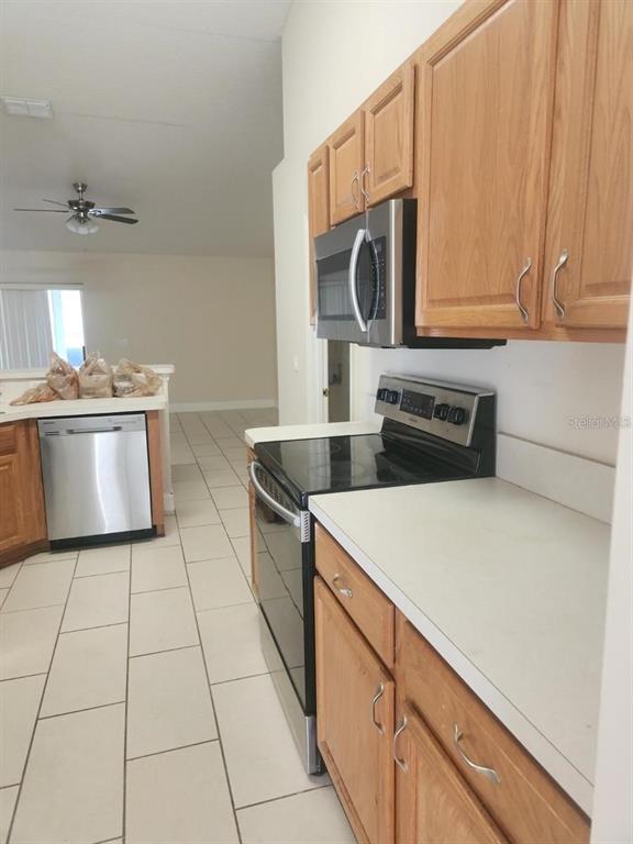 11608 Southwest 50th Circle Ocala, FL 34476 - Photo 4 of 7 a kitchen with stainless steel appliances a sink stove and cabinets