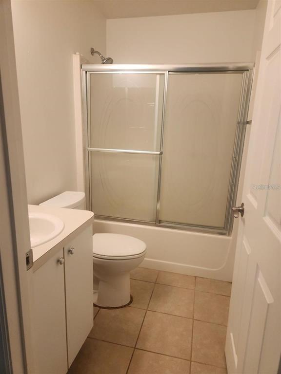 11608 Southwest 50th Circle Ocala, FL 34476 - Photo 6 of 7 a bathroom with a granite countertop sink toilet and shower