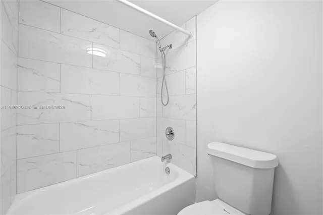 a bathroom with a bathtub and a toilet