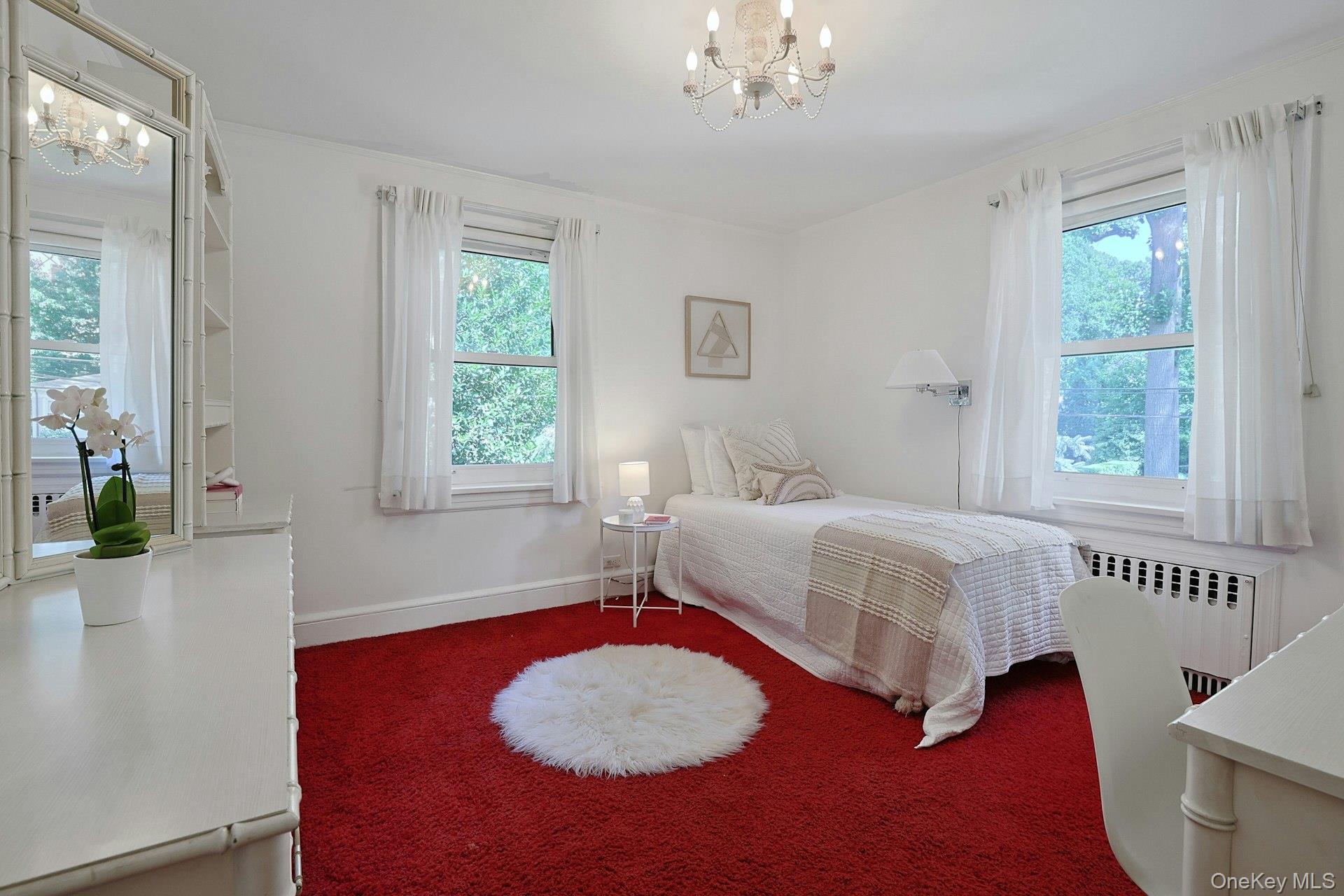 17 Elm Road Scarsdale, NY 10583 - Photo 27 of 38 Another lovely second-floor bedroom is filled with natural light from multiple windows and offers excellent proportions.