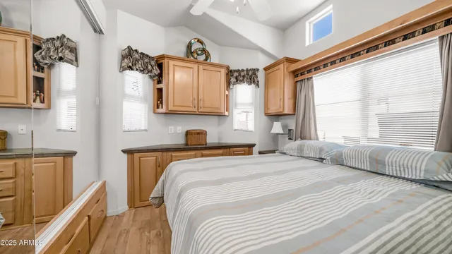 a bedroom with a bed a window and dresser