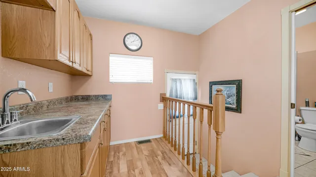 a kitchen with a sink cabinets and a window