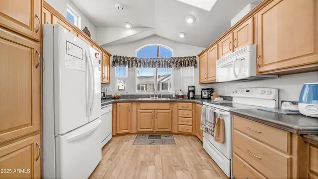 a kitchen with granite countertop stainless steel appliances a sink and cabinets
