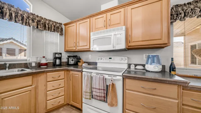 a kitchen with stainless steel appliances granite countertop a sink and cabinets