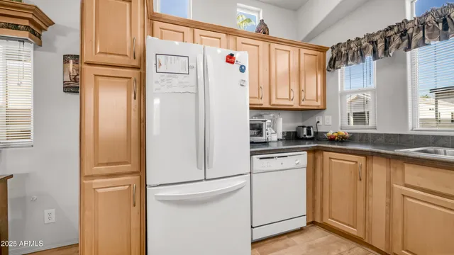 a white refrigerator freezer sitting in a kitchen