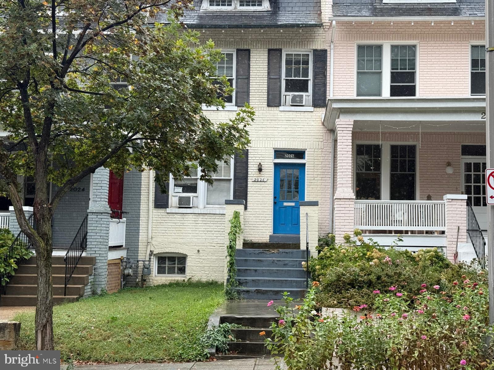 a front view of a house with a garden
