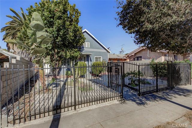 a view of a wrought iron fences in front of house