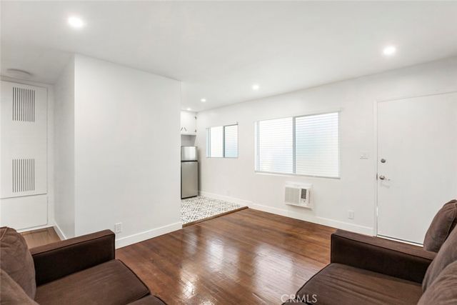 a living room with a bed furniture and a window