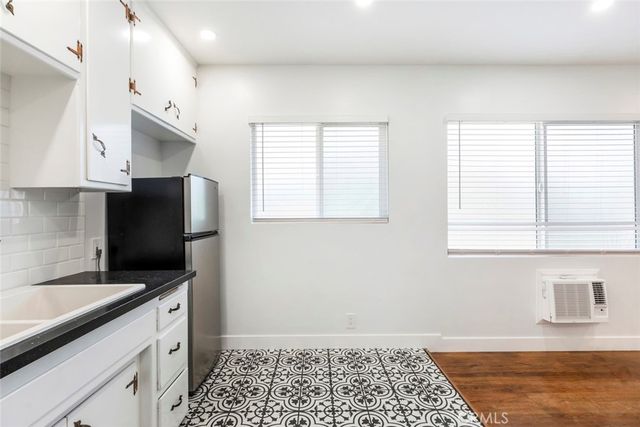 a kitchen with stainless steel appliances granite countertop a sink stove and microwave