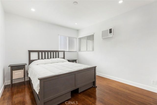 a bedroom with a bed and a night stand