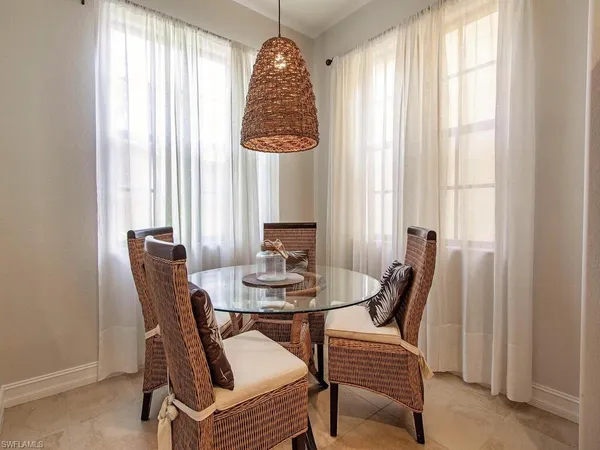a dining room with furniture and window