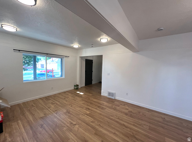 545 23rd Street Ogden, UT 84401 - Photo 8 of 28 Spacious interior featuring wood-finish flooring, white walls, and multiple flush-mount ceiling lights