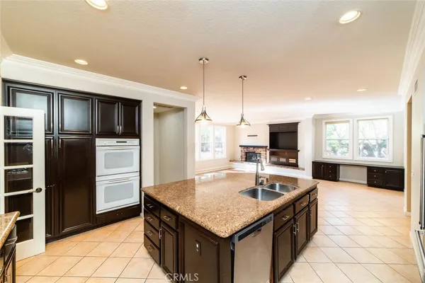 a kitchen with stainless steel appliances granite countertop a sink refrigerator and microwave