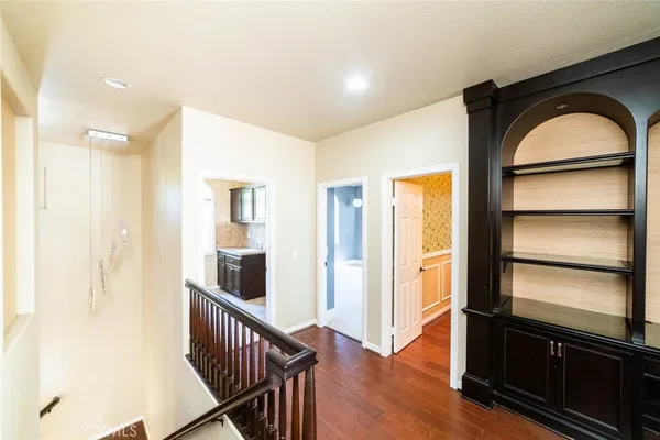 a view of hallway with wooden floor and windows
