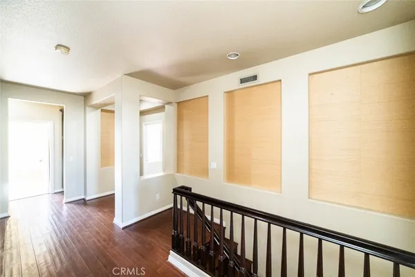 a view of hallway with wooden floor and stairs