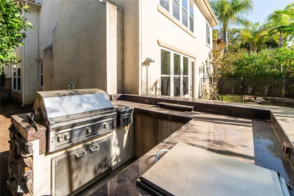 a view of a patio with chairs next to a yard