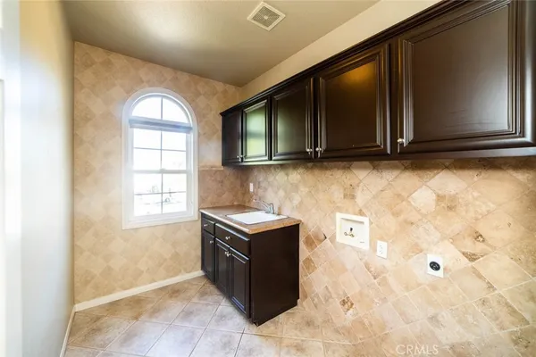 a kitchen with granite countertop a stove top oven microwave and cabinets